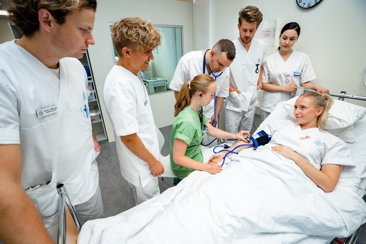 Studenter pleier baby dukke i ferdighetssenteret